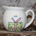 Rae Dunn give Creamer with Present on Front and joy to the world on back.