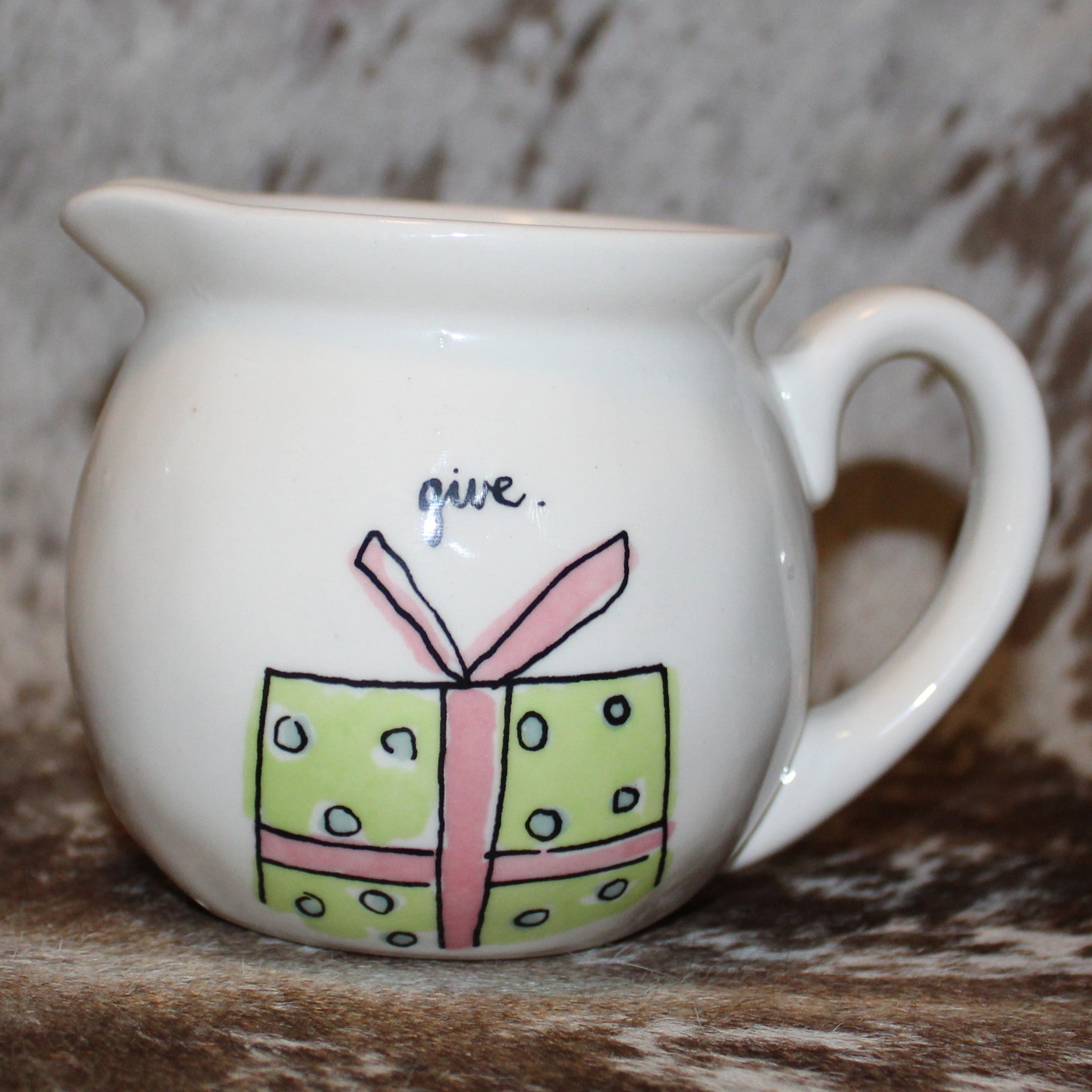 give Creamer with Present on Front and joy to the world on back.